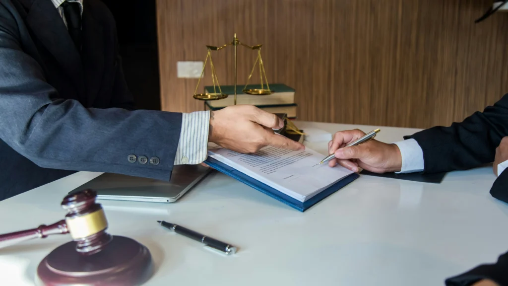 Attorney and client signing paperwork during a case review with a Chicago Brain Injury Lawyer.