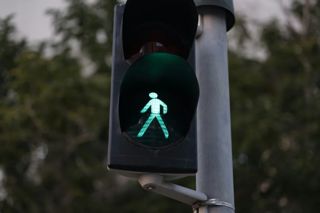 Green pedestrian traffic light signaling safe crossing