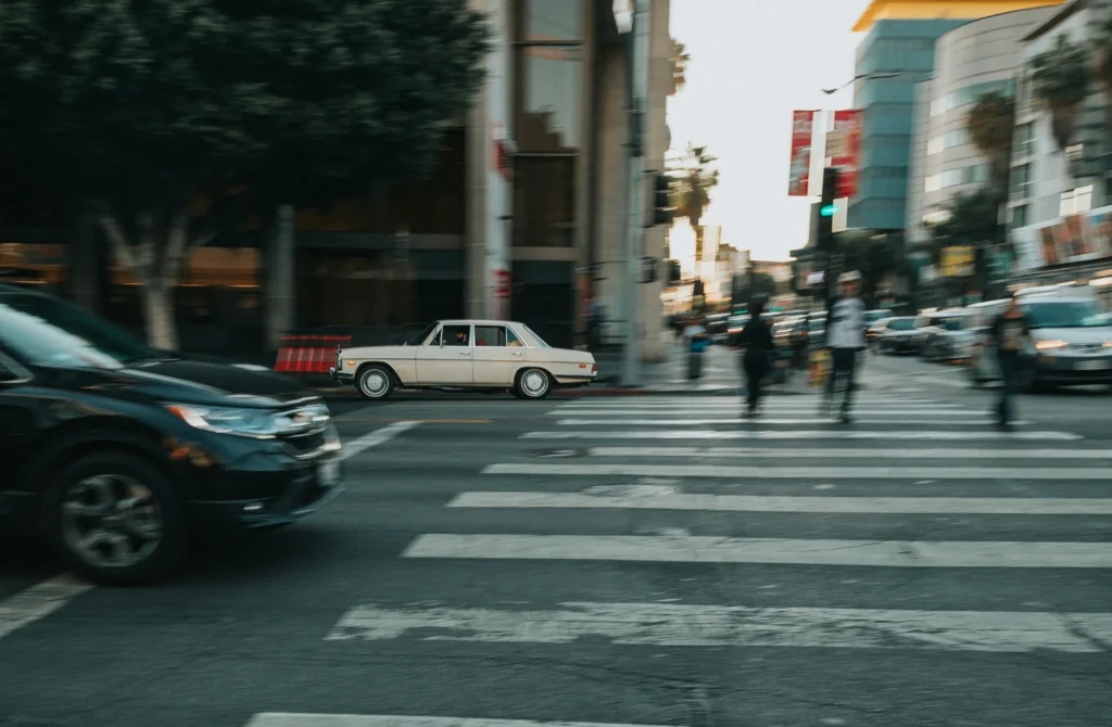 Pedestrians and vehicles sharing a crosswalk where a Chicago pedestrian accident lawyer might handle injury claims.