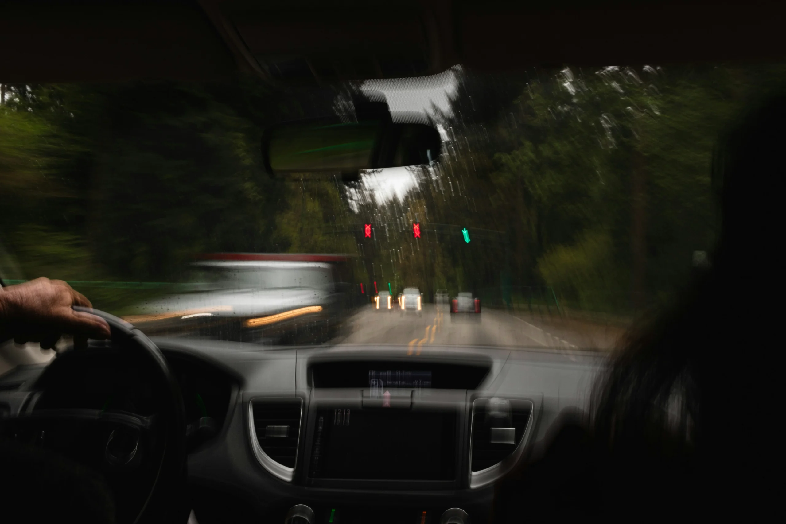 View from car windshield of car speeding down the street