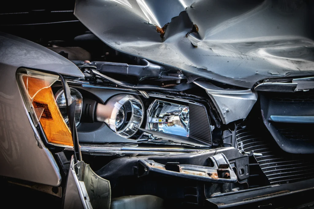 broken front end of a silver car that was involved in a crash