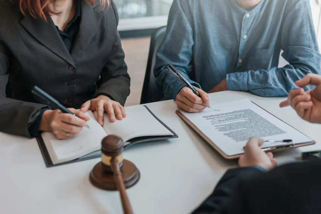 Attorneys reviewing legal paperwork for tendonitis workers' compensation settlements.