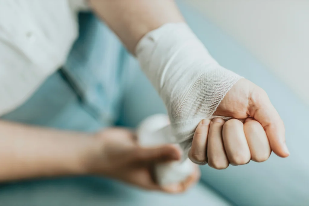 Close-up of a bandaged wrist, showing common injuries in tendonitis workers' compensation settlements.