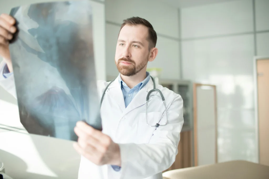 Doctor analyzing medical scans linked to late diagnosis lawyer cases