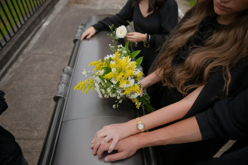 Family placing flowers on casket after wrongful death case