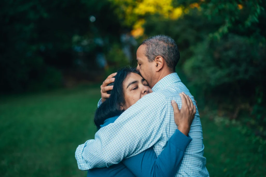 Grieving couple hugging outdoors after speaking to chicago wrongful death attorney