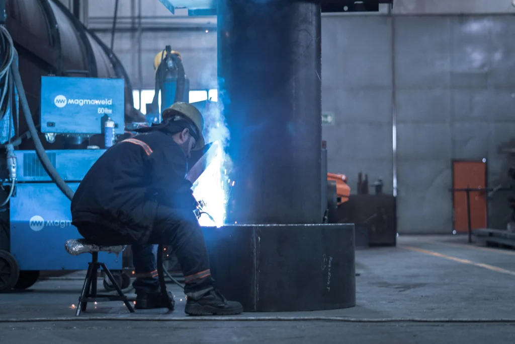 Industrial worker welding steel with protective gear