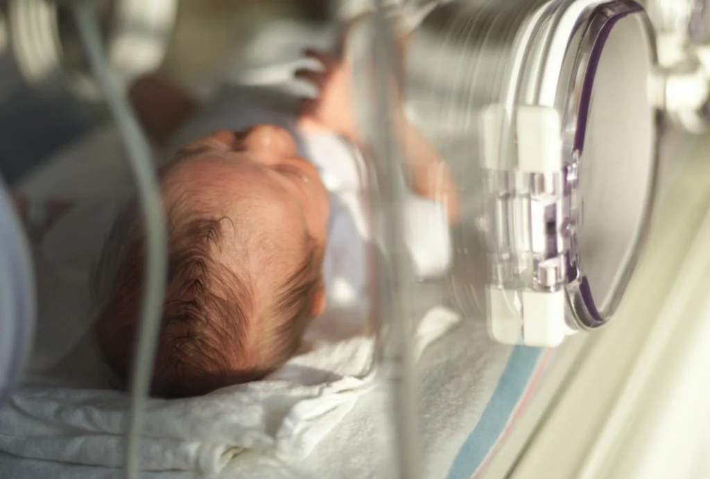 Newborn in incubator