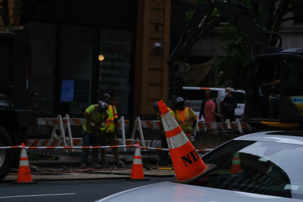 Roadwork crew with safety cone