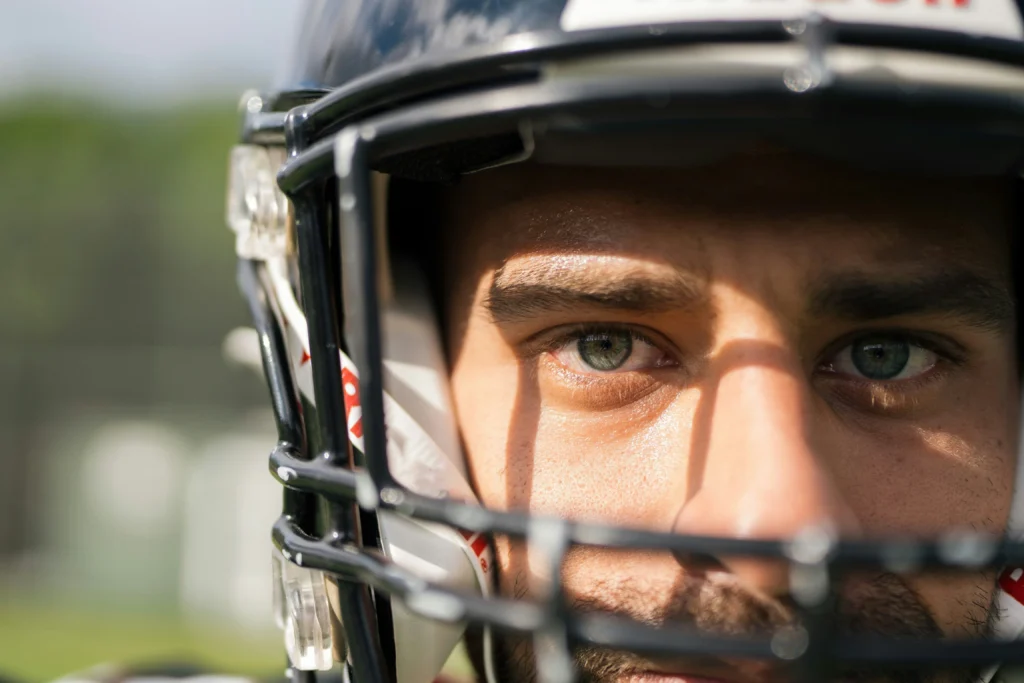 Close-up of football player’s eyes behind helmet