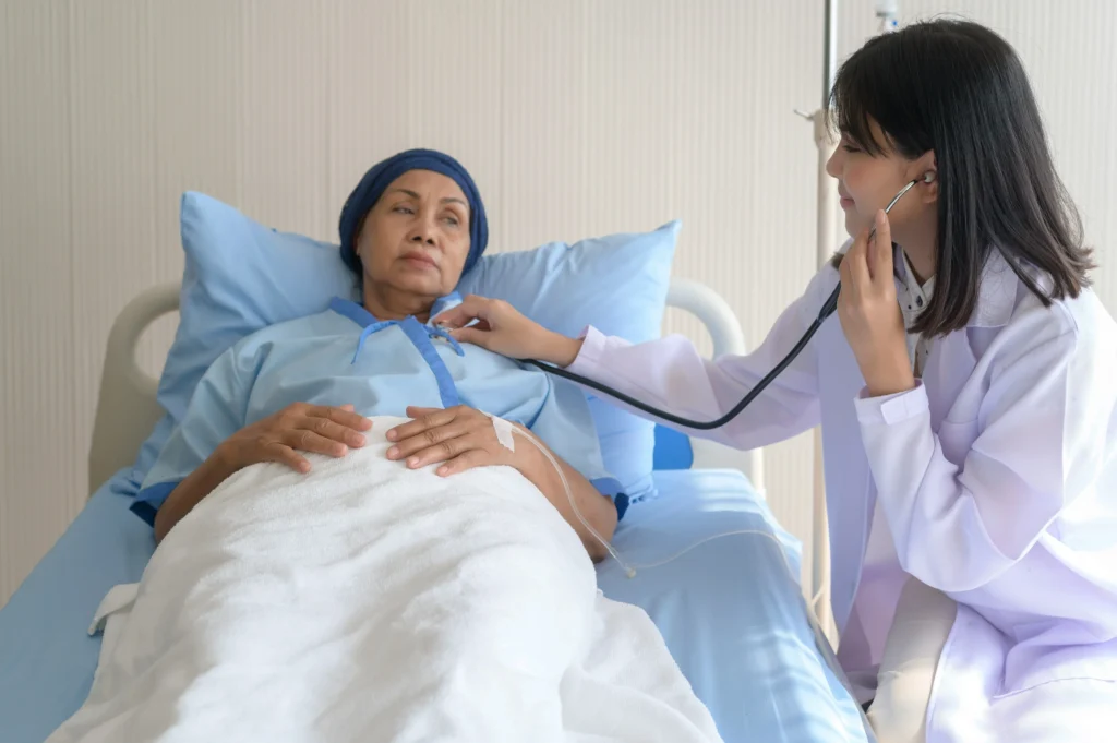 Doctor checking patient in hospital bed — support from a cancer misdiagnosis lawyer can protect patient rights.