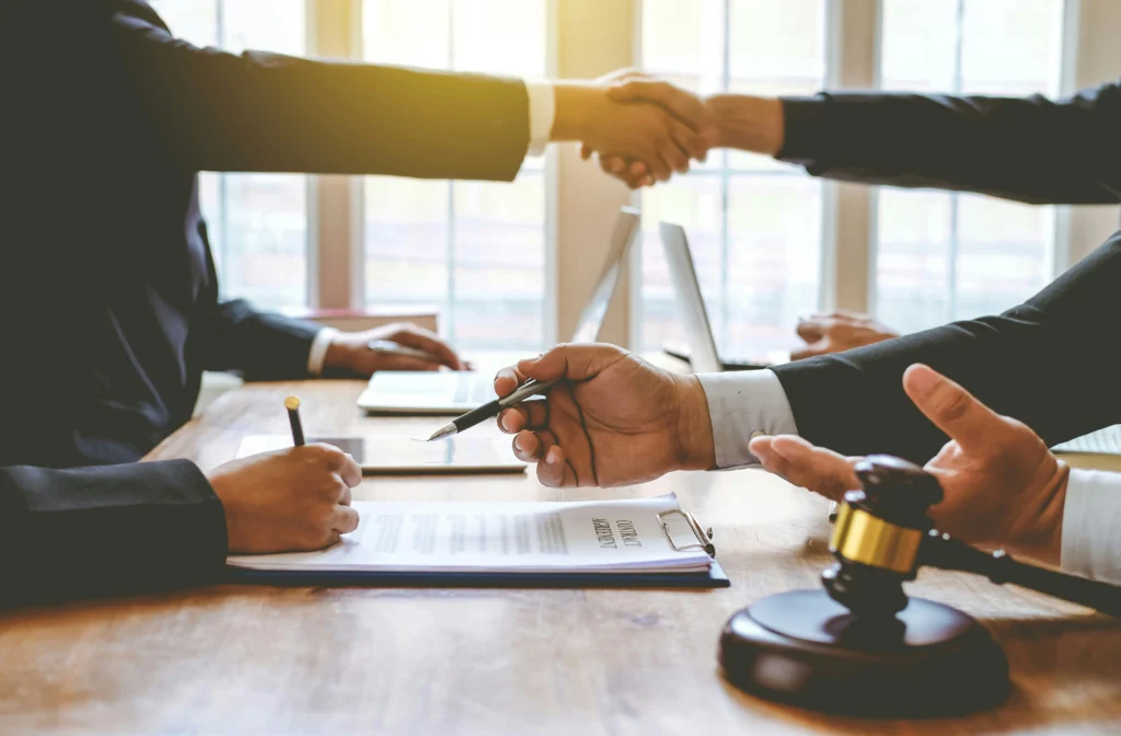 Illiinois lawyers shaking hands after resolving settlement for medical malpractice case