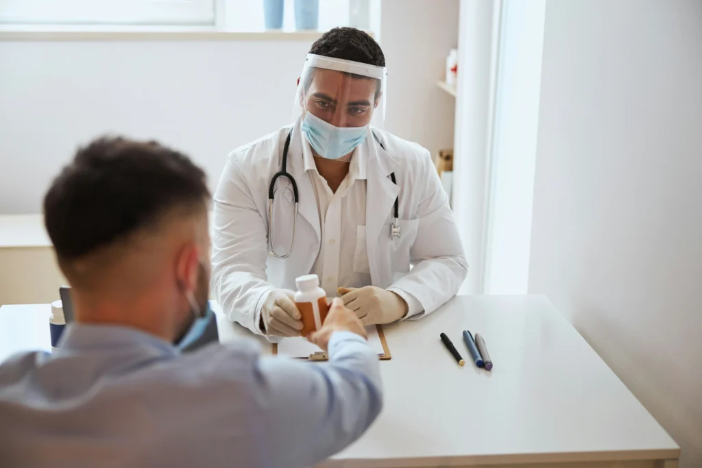 Physician handing medication during consultation, where a cancer misdiagnosis lawyer may help review medical errors.