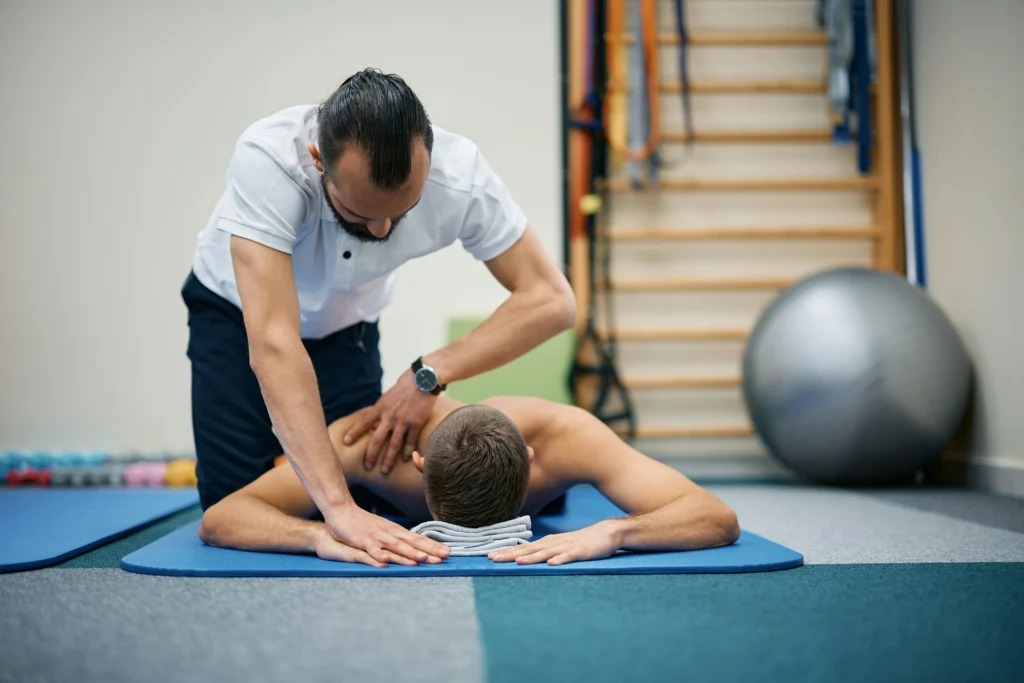 Physical therapist treating back pain patient recovering under Southwest Airlines workers compensation coverage.