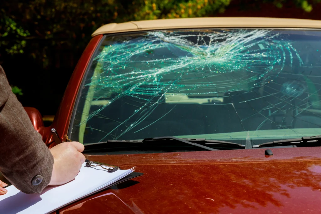 Rockford Illinois car accident lawyer inspecting damaged windshield after car crash