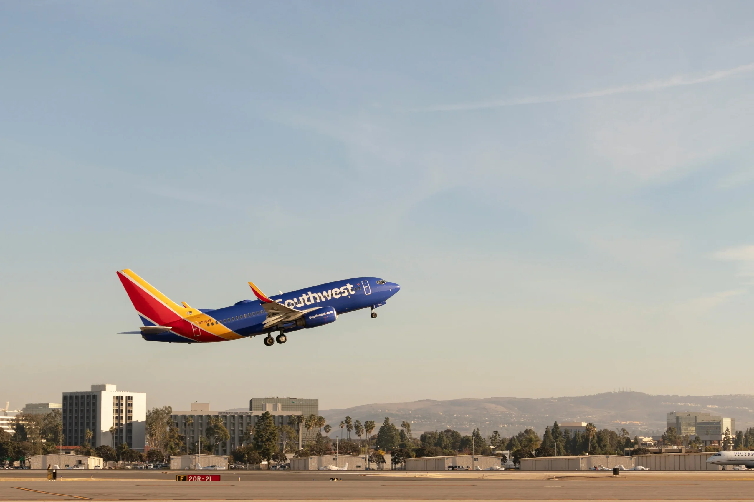 Southwest Airlines jet taking off near airport buildings, illustrating Southwest Airlines workers compensation cases.
